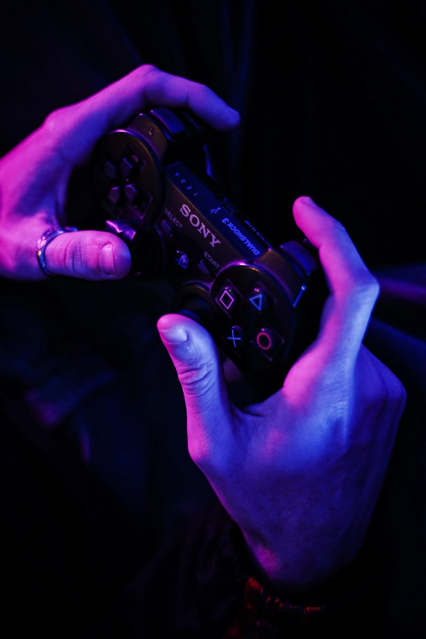 Person Holding PlayStation 3 Controller